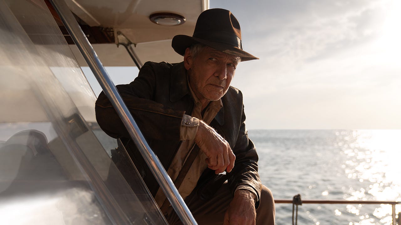 IGN movies review — IGN reviewed Dial of Destiny by yelling 'Spielberg did it better' into a museum gift shop fedora.